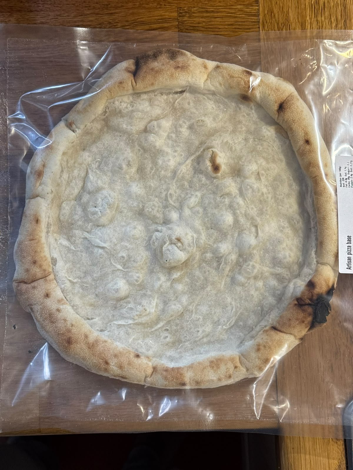 An individually sealed Italian Secret artisan pizza base, ready for the kitchen