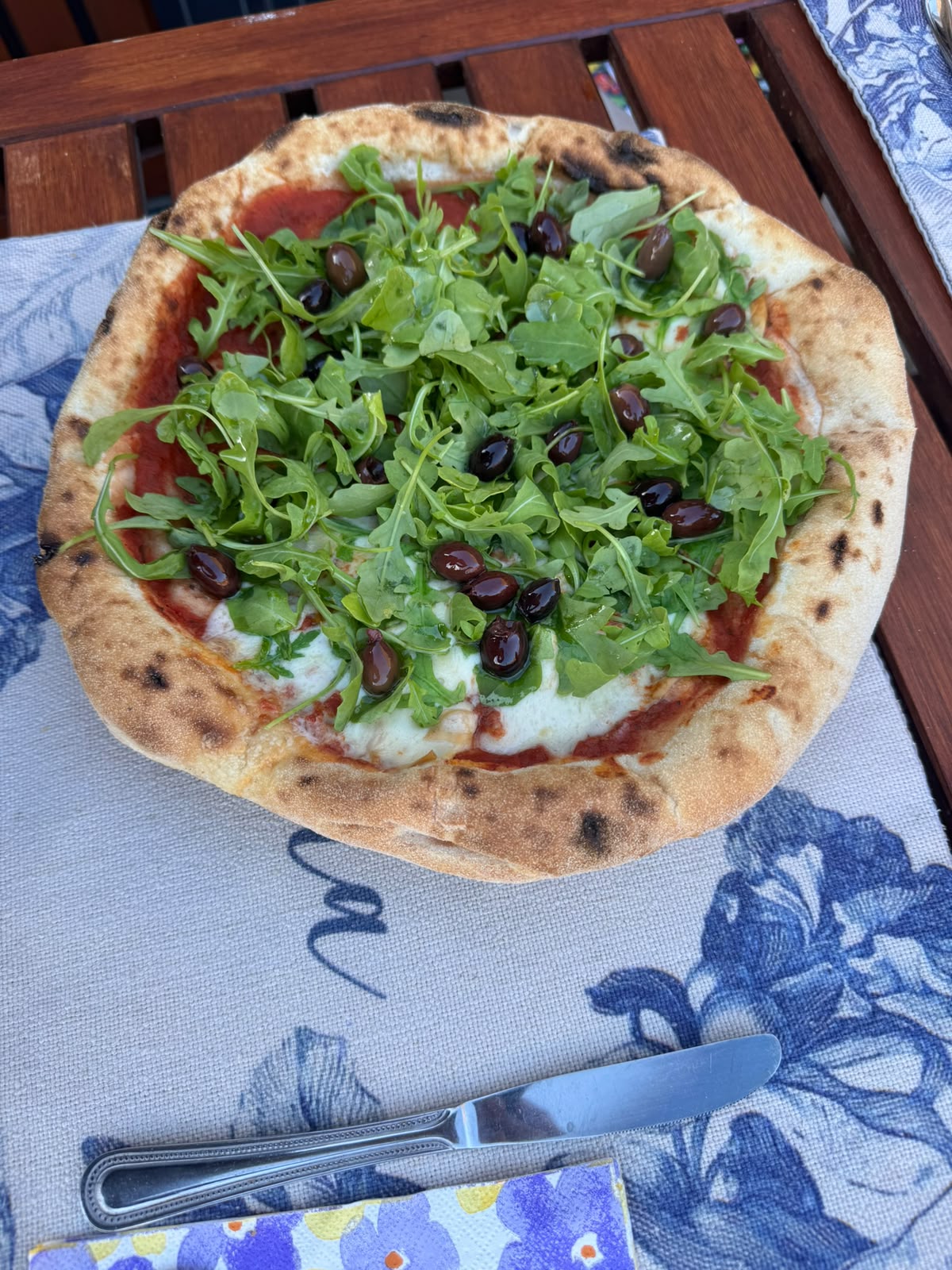 Italian Secret pizza finished with fresh toppings