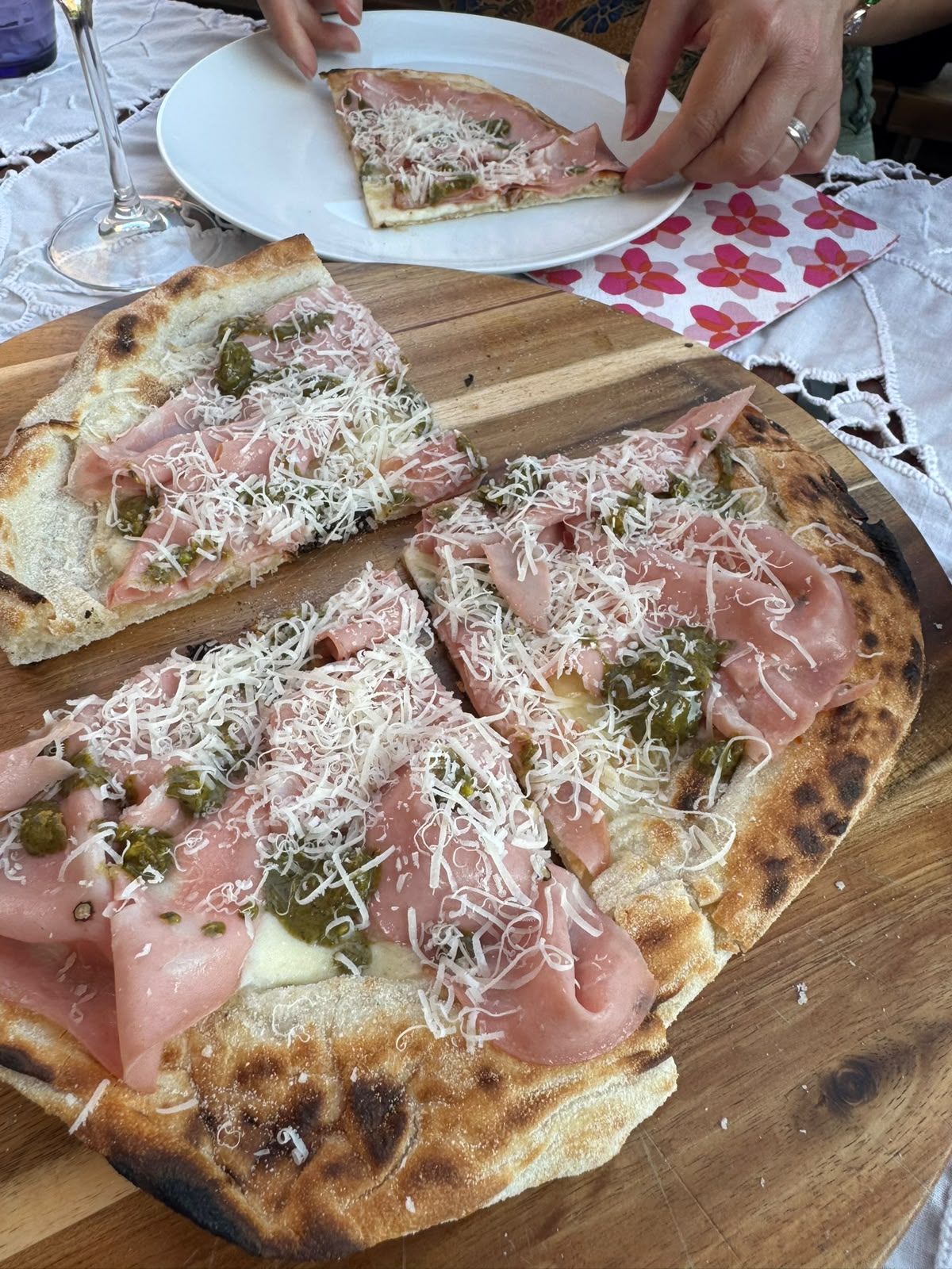Italian Secret pizza finished with ham and green pesto